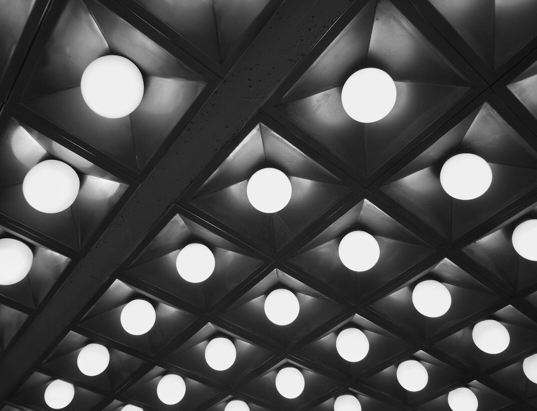 Overhead studio lighting grid with LED panels and spotlights