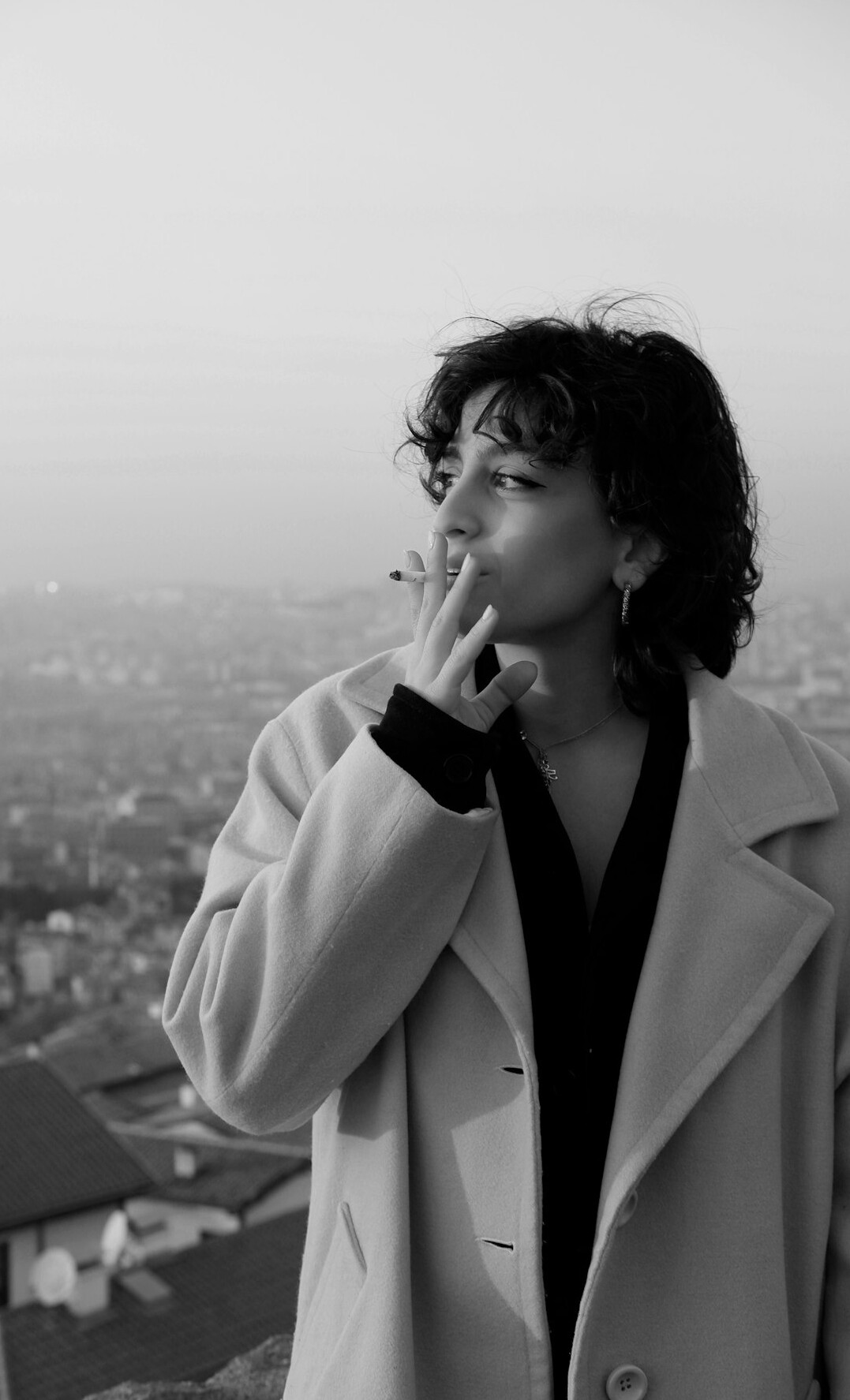 Portrait of a woman with curly hair wearing a blazer